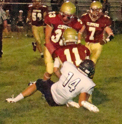 CHAD MARTIN (14) sacks Newburyport quarterback Michael Shay in first quarter action Friday. Shay was on the run from the relentless Pioneer defense all night. (Tom Condardo Photo)