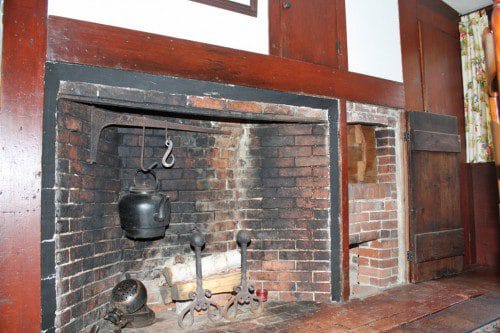 FIREPLACES were necessary to provide both warmth and a means of cooking in the homes of the early inhabitants of town and as such are quite prominent in all of the homes on the historic house tour. This fireplace in the present-day dining room of the Joseph Tapley House includes a beehive oven at the far right, one of two such ovens in the home. (Maureen Doherty Photo)