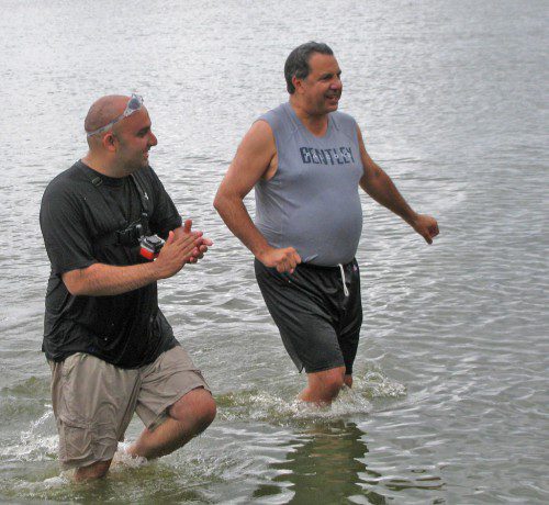 SCHOOL School Superintendent Dr. Stephen Zrike, left, and Town Administrator Stephen P. Maio emerge after plunging into Lake Quannapowitt on Saturday. Just before the plunge, Wakefield High School Diversity Leaders Nicole Galli, Courtney Sullivan, Julia Derendahl, Brian Dickey and Dylan Melanson took turns shaving Dr. Zrike’s head, fulfilling a pledge to do so if Wakefield students read 10,000 books over the summer. (Mark Sardella Photo)
