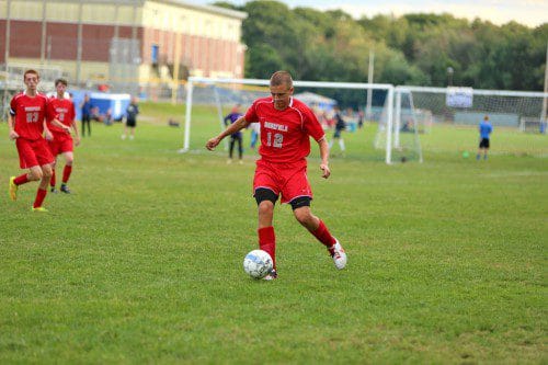 JOE HURTON, a senior, gets ready to send the ball forward during Wakefield’s win against Stoneham. The Warriors had another fine effort against Wilmington yesterday afternoon at Walton Field, but lost a 1-0 game. (Donna Larsson File Photo)