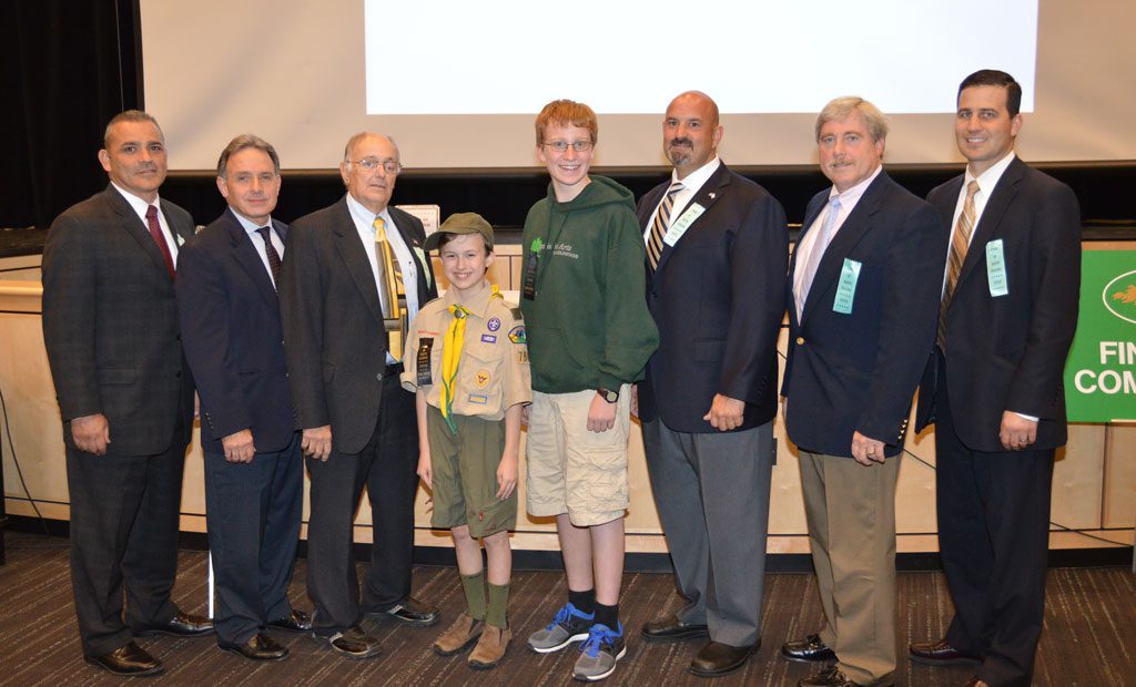 LOCAL SCOUTS Sam Barrette and Christopher Nearing joined the Board of Selectmen while working on their communication badges at Town Meeting. From left: Selectmen Joe Foti, jeff Yull, Robert Mauceri, Sam, Christopher, Selectmen Mike Prisco, Stephen O’Leary and Town Administrator Michael Gilleberto. (Bob Turosz Photo)