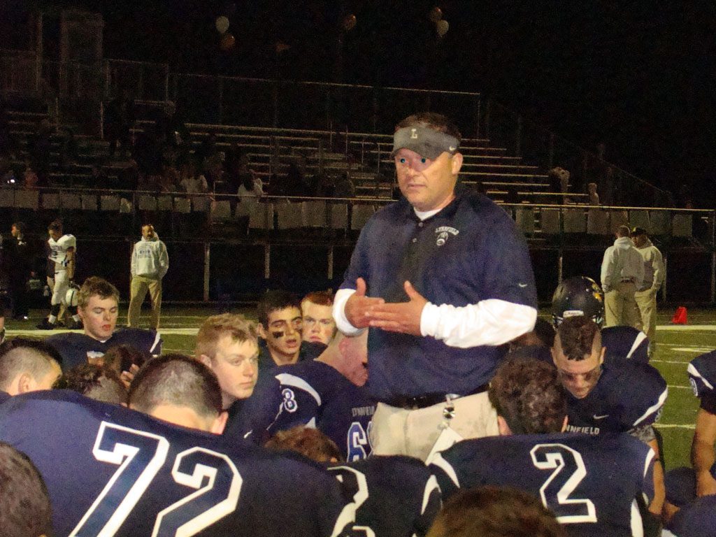 HEAD COACH Neal Weidman addresses his football squad after posting the 50th win of his coaching career at Lynnfield Friday night. (Tom Condardo Photo)