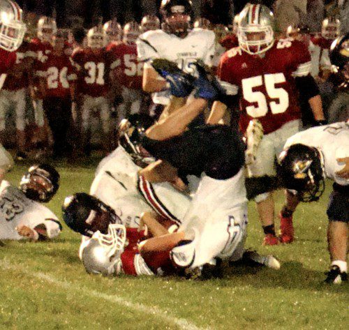 UPSY DAISY. Drew Balestrieri (44) takes a different angle to bring down this Amesbury runner Friday night. (Tom Condardo Photo)