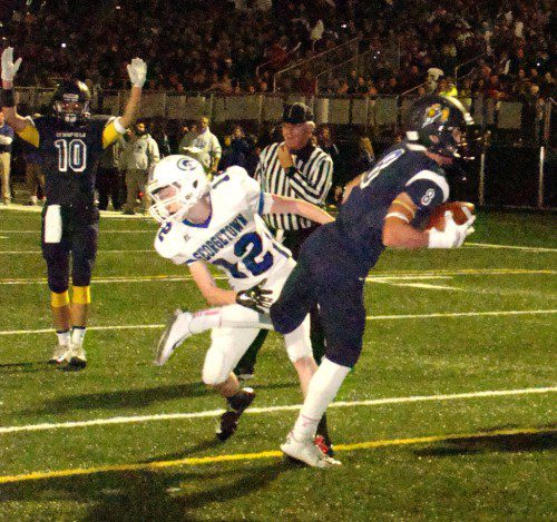 CAPTAIN Cam Rondeau (8) reaches the end zone after catching a 10-yard pass from captain Danny Sullivan in Friday's 42-0 win over Georgetown. Captain Jon Knee (10), who scored the first Pioneer TD at the new field, makes the call. (Tom Condardo Photo)