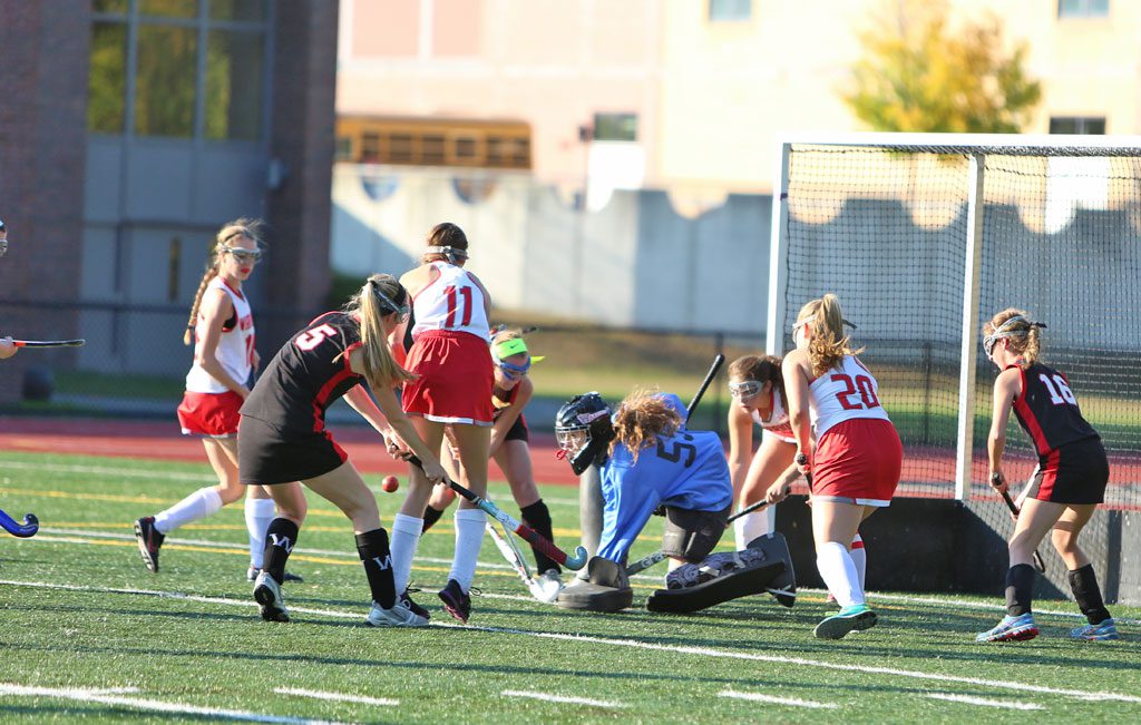 SENIOR GOALIE Miriam Wood (#55) turned away 25 shots by Winchester yesterday afternoon at Beasley Field. Shannon Livingston (#11) and Hayley Kaddaras (#20) help out on the play. The Warriors gave up three first half goals and dropped a 3-0 contest. (Donna Larsson Photo)