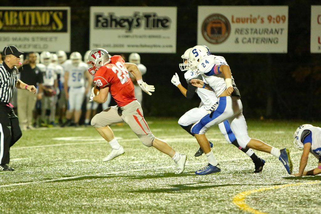 LUKE MARTIN, a senior RB (#28), gained 222 yards on 16 carries and scored all four Warrior touchdowns in Wakefield’s 27-0 triumph over Stoneham on Friday night at Landrigan Field. (Donna Larsson Photo)