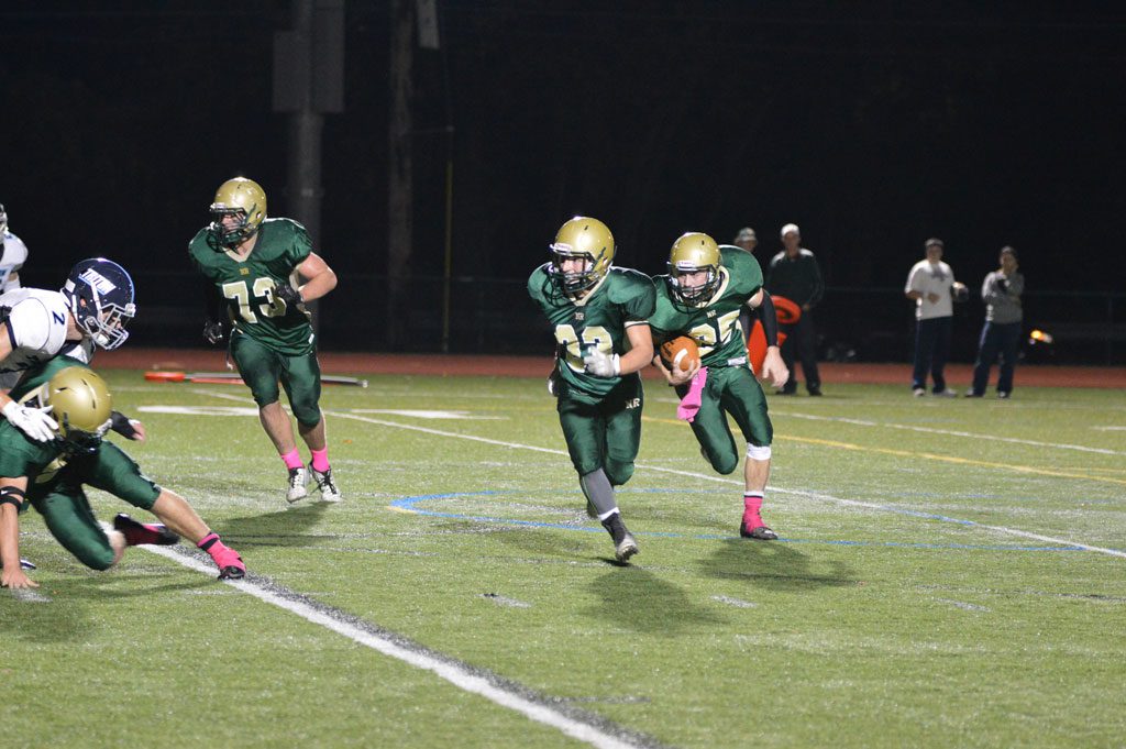 SOPHOMORE Matt McCarthy, (25), at right, scored all three North Reading touchdowns against Triton Friday night, including this one from four yards out in the second quarter, behind the blocking of John Merullo, (33) and Kevin Farrelly, (73). (Bob Turosz Photo)