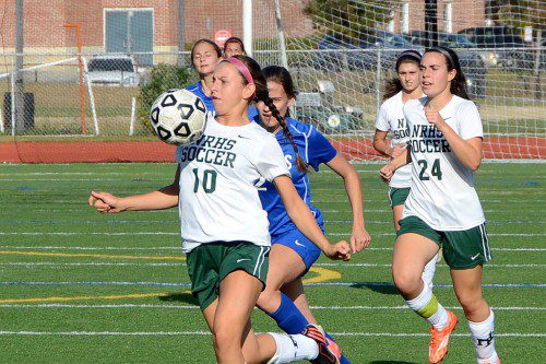 EYES ON THE BALL. Hornet senior Cole Godzinski (10) controls the balll for North Reading. Number 24 for Hornets is Tori Brown. (John Friberg Photo)