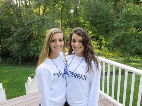 SUPER spirited students. Modeling the long-sleeved LHS Superfan t-shirts they designed are Lexi Yannone (left) and Olivia Skelley. The girls created the LHS Superfan Club to boost school spirit. They are selling Superfan Kits to students and residents that include the T-shirt, beads and either a cow bell or pom poms for $10 in advance of the first football game to be played at the new stadium on Oct. 10. (Courtesy photo)