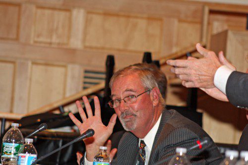 RETIRING Town Administrator Bill Gustus acknowledges the Town Meeting voters who offered him a standing ovation Oct. 20. It was his last Town Meeting as he is retiring Jan. 1 after 12 years at the helm. (Maureen Doherty Photo)