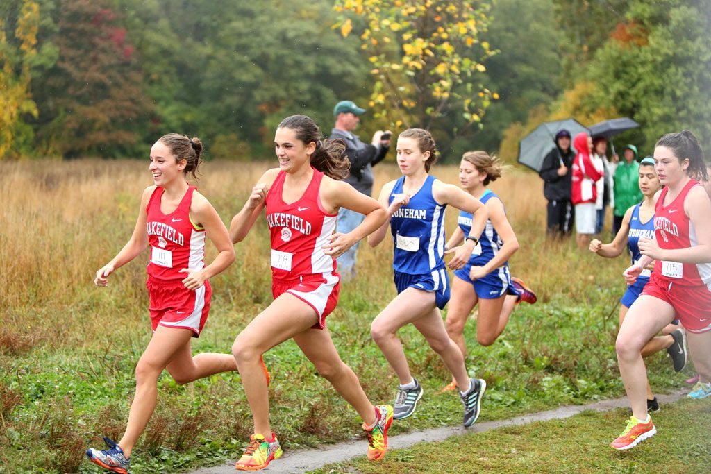 SENIOR EMILY Hammond (left) and junior Sara Custodio (second from left) lead the pack of runners during a recent meet. The Warriors returned home on Tuesday and had many PRs against Wilmington in a 15-45 victory. (Donna Larsson File Photo)