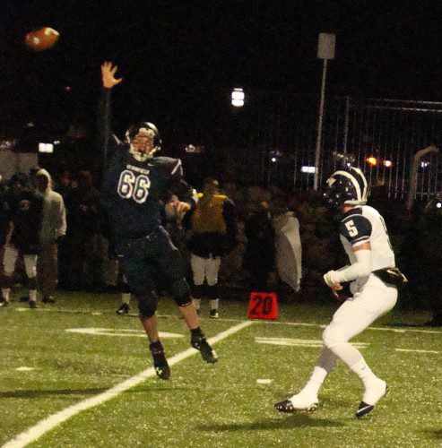 PIONEER defensive lineman Al MacLachlan (66) leaps in an attempt to block a pass from Swampscott's Devin Conroy (5). Lynnfield is 9-0 after defeating the Big Blue 35-6 to advance to the division championship. (Tom Condardo Photo)