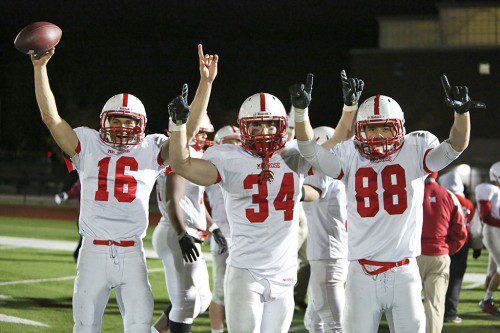MELROSE FOOTBALL has plenty of reason to celebrate. On Friday they knocked out top ranked, undefeated Woburn 20-19 in the D3 Northwest playoffs. Pictured celebrating after the victory are (left) quarterback Jake Karelas, Jack Hickey and Cameron Hickey. (Donna Larrson photo)