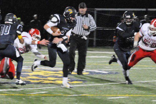 CAPT. Dan Sullivan (2) picks up 30 of his 180 yards rushing against Saugus. He also scored a TD in the playoff win. (Jack Schnelle Photo)