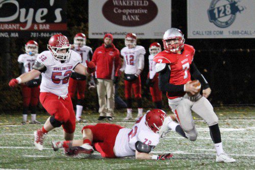 SENIOR QB Anthony Cecere (#7) eludes the tackle of Burlington’s Adam Jankowski (#72) and outruns Brad Basham (#52). Cecere ran for one touchdown and threw for another as the Warriors posted a 14-13 victory over Burlington on Friday night at Landrigan Field.