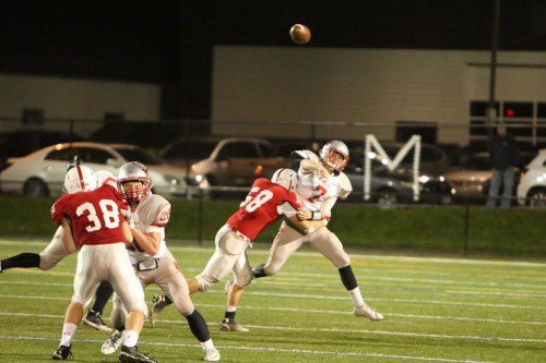 SENIOR QB Anthony Cecere (#7) is pressured by Melrose’s Mike Doucette during Friday’s Div. 3 Northwest quarterfinal loss. Cecere completed eight of 24 passes for 100 yards with three interceptions as he was under constant duress. (Donna Larsson Photo)