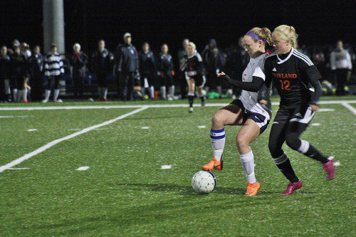 SENIOR CAPTAIN Paige MacEachern (15) fights for position against a Wayland defender during the Pioneers’ 2-0 victory over the Warriors in the first round of the Division 3 North state tournament. (Dan Tomasello Photo)