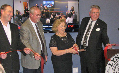 THE VISIONARY leadership provided by the late Al Merritt in the development of MarketStreet was commemorated with the dedication of the Al Merritt Media and Cultural Center Friday night. Participating in the ribbon cutting were, from left: Ted Tye of National Development, Town Administrator Bill Gustus, Beverly Merritt and Chairman of the Board of Selectmen Dave Nelson. (Mark Sardella Photo)