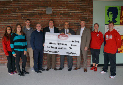 FROM THE LEFT are Wakefield Memorial High students with school administration and Wakefield Co-op Bank management: Nicole Galli; Courtney Sullivan; Brian Dickey; Chris Callanan, School Committee chairman; Mike Wolnik, Wakefield Co-operative president & CEO; Dr. Stephen Zrike, schools superintendent; Chad Moore, Wakefield Co-operative vice president, Personal Banking; Julia Derendal; Dylan Melanson.