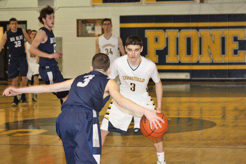 JUNIOR point guard Brendan Sullivan (white) finished with 15 points, six assists and six rebounds during the Pioneers' 71-70 victory over Manchester-Essex on Dec. 16. (File Photo)