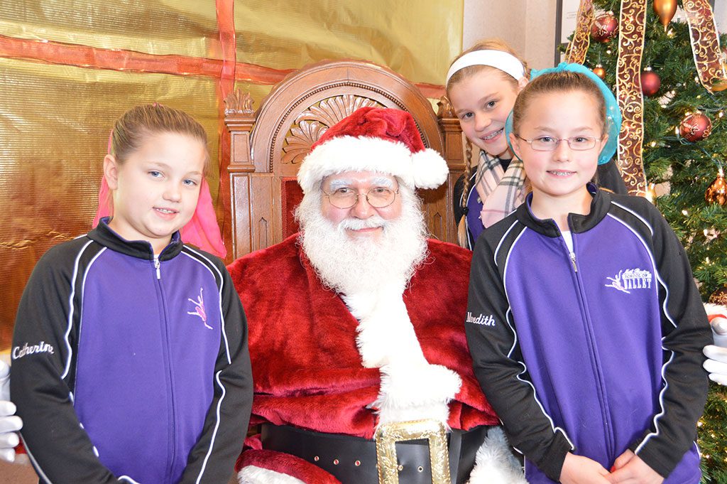 THE CASEY GIRLS — Catherine, Caroline and Meredith — stopped by to see Santa at the Reading Co–operative Bank during North Reading's ninth annual Holiday Lighting Festival sponsored by the Reading–North Reading Chamber of Commerce. (Bob Turosz Photo)