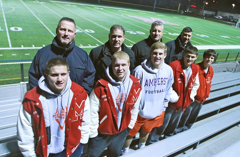 HISTORY IS remade as two generations of Melrose High School Red Raiders take the trip to Foxboro for Super Bowl. Members of the last MHS football team to go to Super Bowl in 1982 will see five of their sons make the trip this Saturday. They are: (pictured from left) John Mercer and son Zack, John McLaughlin and son Brian, Chris Hickey and son Jack, and George Karelas and sons Jake (l) and Luke (r). Melrose will take on Dartmouth on Sat. at 6:00 p.m. at Gillette Stadium and hope to earn their first Super Bowl victory. (Donna Larsson photo)