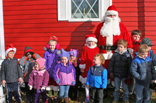 SANTA CLAUS arrived in town Saturday afternoon with an escort by Engine 1 from the Fire Department. As soon as he got settled inside his headquarters on the Veterans Memorial Common, good little girls and boys met with him to go over their Christmas wish lists. The jolly old elf’s visit was sponsored by the Wakefield Lions Club. His headquarters will be open this weekend from 1 to 5 p.m. and weekdays from 3:30 to 7 p.m., beginning Wednesday. (Gail Lowe Photo)