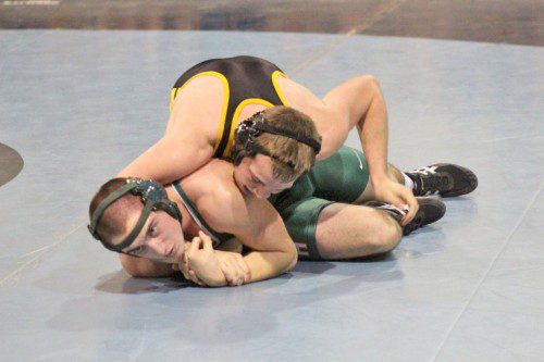 SENIOR CAPTAIN Austin Bradley (on top) defeated his Hopkinton opponent by a 7-0 decision in the 182 lbs. on Saturday, Dec. 13. The Black and Gold have opened the 2014-2015 season with a 2-1 record. (Courtesy Photo)