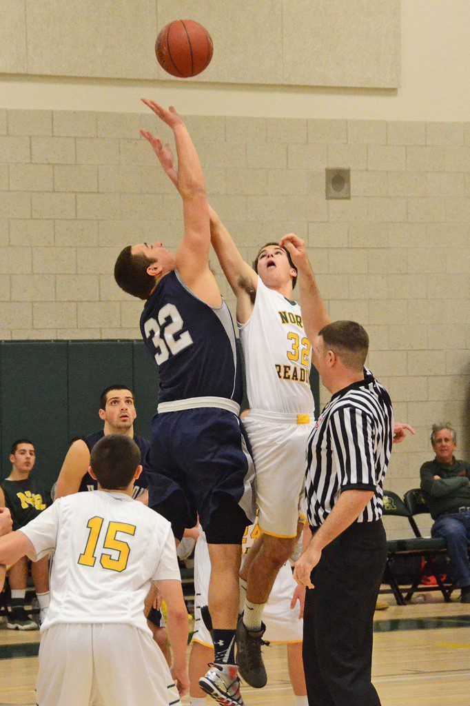 SENIOR TOM LEWIS battles for the opening tip off against Hamilton–Wenham. (John Friberg Photo)