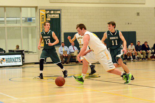 HORNET VS. HORNET. Junior Tri-Captain Nic O'Connell chases down a loose ball and heads to the hoop duringa tight matchup between the North Reading and Manchester–Essex Hornets, won by North Reading, 70–69. (Deanna Castro Photo)