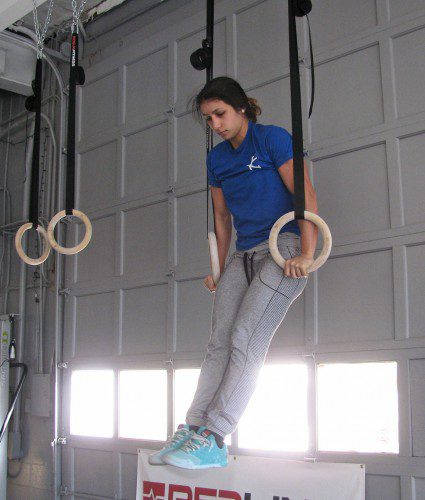 OWNER DANIELLE RESHA works out on the rings at her CrossFit 128 gym at 581 Salem St.