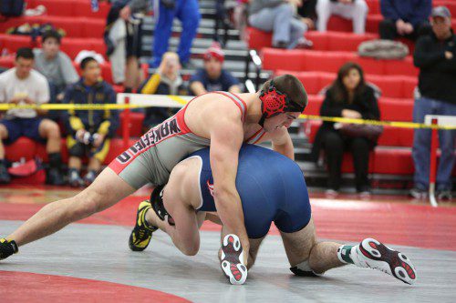 DAN WENSLEY, a senior captain (left), moved up to the 285 weight class to wrestle last night against Burlington. Wensley pinned John Luminello at 44 seconds for six points as the Warriors went on to win, 40-36, at the Charbonneau Field House. (Donna Larsson File Photo)