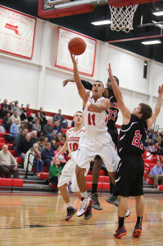 SENIOR GUARD Chris Calnan (#11) scored 20 points including a clutch basket and free throw as the Warriors edged Wilmington, 49-48, on Friday night at the Wilmington Middle School. Calnan also five rebounds, two steals, and two assists. Also in the photo is junior forward Tighe Beck (#10). (Donna Larsson File Photo)
