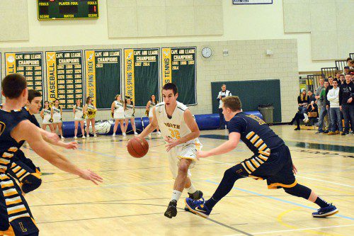 SENIOR  Tom Lewis heads to the hoop in traffic in a thrilling game in which the Hornets suffered a disappointing 64-61 loss to rival Lynnfield. (Deanna Castro Photo)