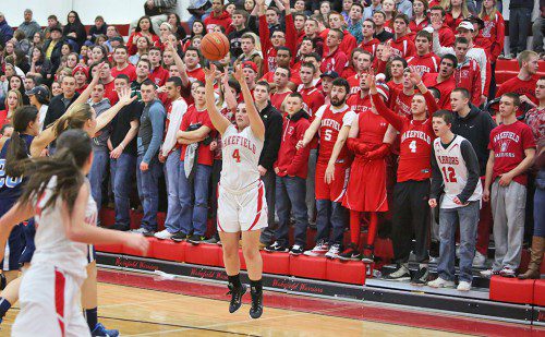 DANIELLA IANNUZZI, a senior forward (#4), launches a three-point shot during last night’s Div. 2 North Tournament game against Triton at the Charbonneau Field House. Iannuzzi scored a game high 15 points to lead the Warriors to a 55-38 first round triumph. (Donna Larsson Photo)
