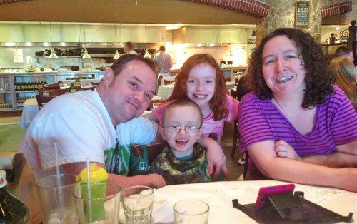 RONAN CLANCY, born with Hemiplegic Cerebral Palsy, is shown with his parents Duane and Elizabeth Clancy and his sister Saoirse. Thanks to the fundraising efforts of Laurie Hunt and others in the community, Ronan’s dream is about to come true. A brand new adaptive bike has been purchased and will be customized to meet his needs.