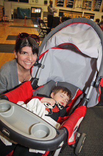 LITTLE Asher Donahue, 2, doesn't realize it yet, but he slept through one of the busiest town elections in recent memory while accompanying his mom, Kim Baker-Donahue, to the polls Monday afternoon. The big draw was the race for selectman between Katy Shea and Chris Barrett as about 28 percent of the electorate cast a ballot. (Maureen Doherty Photo)