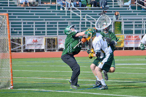 SENIOR CHRISTIAN JESSOP (in white) put the Hornets up, 1–0, with this goal over Manchester–Essex. (John Friberg Photo)