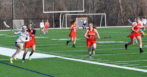 THE MELROSE girls' lacrosse team already has two games under their belts, both close losses to tough squads Lynnfield and Winchester. (Doug Baraw photo) 