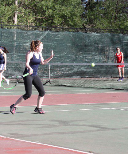 FIRST DOUBLES player Katie Nevils steps into a powerful forehand shot. She and teammate Olivia Skelley combined forces April 20 to shut out their Amesbury opponents 6-0, 6-0. The Pioneers also defeated the Indians 5-0. (Maureen Doherty Photo)