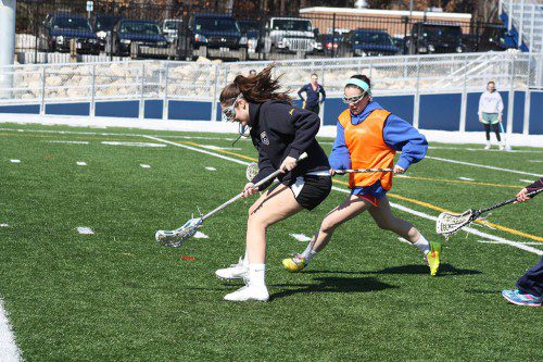 SENIOR attacker Cassandra Miles contains the ball on the field as opposing teammate Olivia Smyrnios looks for an opening in preseason lacrosse practice Thursday on the stadium field. (Maureen Doherty Photo)