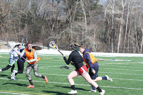 TRI-CAPTAIN Paige MacEachern controls the pace of the game as she outmaneuvers Coach Ethan Blanchette during preseason drills at LHS Thursday. (Maureen Doherty Photo)