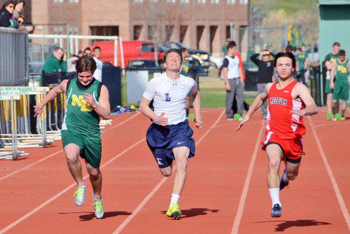 SPRINTER Evan Battaglia (white) battles it out in the 100m race against North Reading and Amesbury opponents. He also runs the anchor leg on the state-qualifying 4x100m relay team and recorded a split of 10.66 in the team’s 46.43 victory over Ipswich last week. (John Friberg file photo)