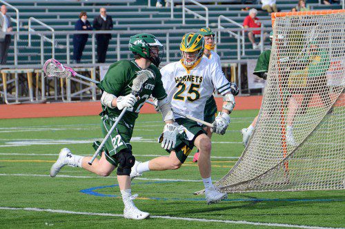 HORNET VS. HORNET. Patrick Riley (25) blocks his Manchester-Essex opponent from the goal. (John Friberg Photo)