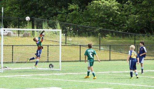 SAVE! Lynnfield U10 goalie Rogan Cardinal tips the ball over the net in a game between Lynnfield and North Reading during East West U10 International Friendly tournament action last weekend at LHS. (Donna Larsson Photo)