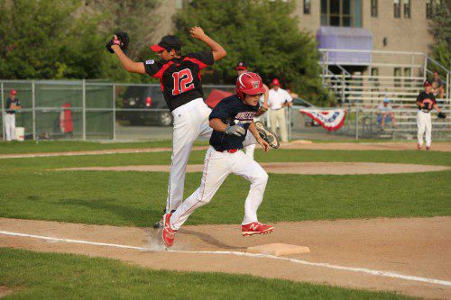 CAL TRYDER is safe at first base as the throw was wide. The Nationals put up a good fight, but fell to undefeated Reading by a 6-2 score on Tuesday night in the District 13 semifinals.  (Donna Larsson Photo)