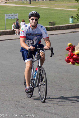WESTON SACCO, M.D., a top fund-raiser for the 11th annual Reid's Ride as a member of the "Doctors Sacco" team and younger brother of the event's namesake, Reid Sacco, approaches the finish line of the 28-mile bike ride. The event raised $190,000 to fight adolescent and young adult cancer. (AmyLou Photography)