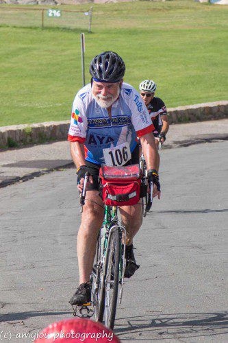 CROSSING the finish line in Gloucester with a smile is Richard Simmons, a member of the Lynnfield Rotary/ReMax team and a top individual fund raiser for the Reid Sacco AYA Cancer Fund. (AmyLou Photography)