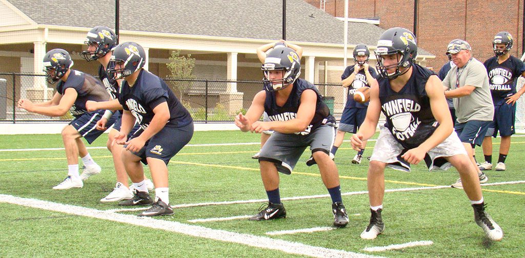 THE PROTECTORS. Pioneer offensive linemen, from left, Trevor Caswell, captain Cam DeGeorge, Mike Stellato, captain Spencer Balian and Brenden Rothwell work on their footwork in an offensive line drill at practice Monday. (Tom Condardo Photo)