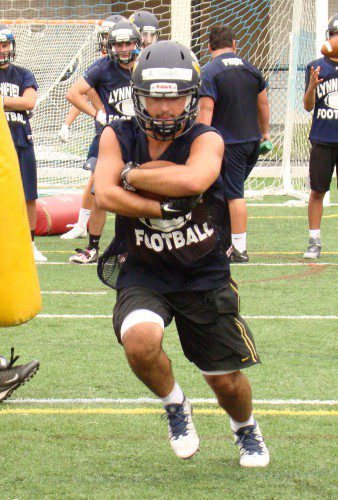 ALEX SODEN, a senior, breaks through the line in a simulated running play during the first of three non-contact practices for the football team on Monday. (Tom Condardo Photo)